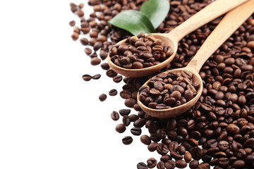 Coffee beans in a spoon on white background