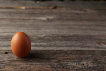 Chicken egg on grey wooden background