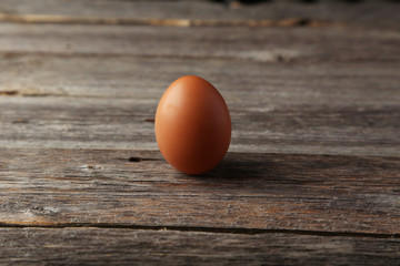 Chicken egg on grey wooden background