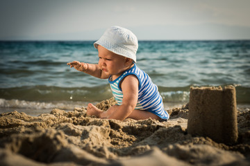  cute baby boy playing beach