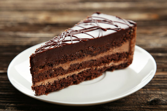 Dark chocolate cake on brown wooden background