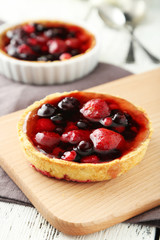 Fresh berry tarts on board