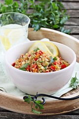 Quinoa salad with vegetables,herbs and lemon.