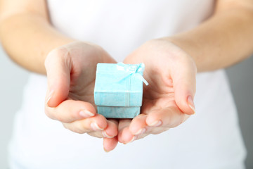 Female hands holding gift box