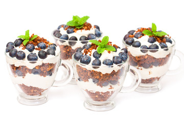 homemade desert with cream chopped cookies and fresh blueberry o