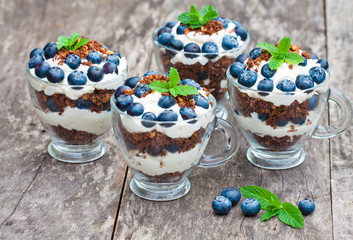 homemade desert with cream chopped cookies and fresh blueberry