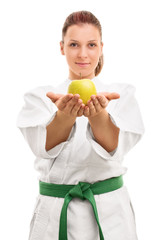 Young girl in kimono offering an apple