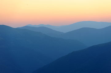 Sunrise over mountains silhouettes