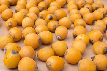 Ripe queen palm dates on floor