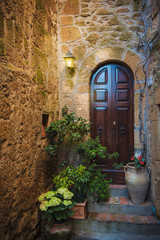 Classic Tuscan door in the village Pitigliano - 83946514