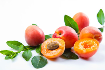 Apricots with leaves on a white background