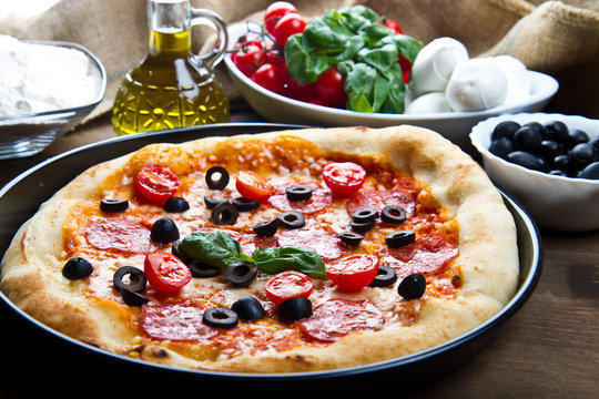  pizza with olives and tomatoes