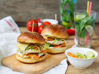 burgers with chicken and stuffed  juicy with cucumber, carrots a