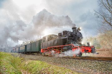 Fototapeta na wymiar Historical steam train on Rugen in Germany