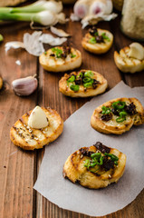 Mini toasts with garlic and dried tomato