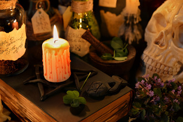 Obraz na płótnie Canvas Magic still life with burning candle and four leaf clover