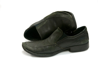 Old black shoes on white background