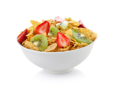 bowl of corn flakes with fruit on white background