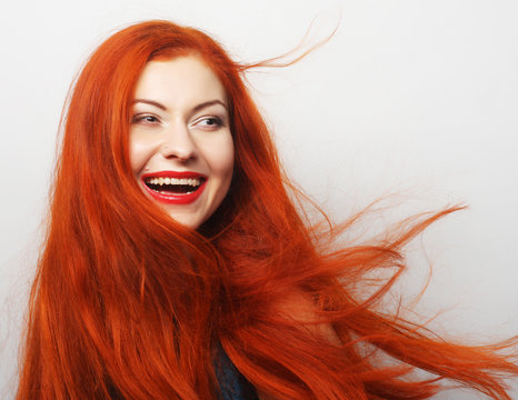  happy woman with long flowing red hair