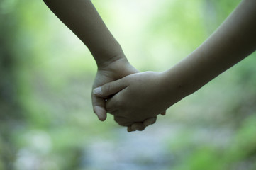 Children holding hands in the park