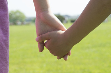 Siblings holding hands in the park