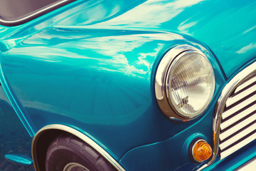 Vintage car detail with blue sky reflection