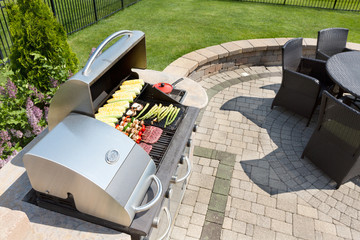 Grilling food on an outdoor gas barbecue - 83951942