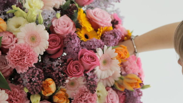 Florist makes a beautiful bouquet from different flowers