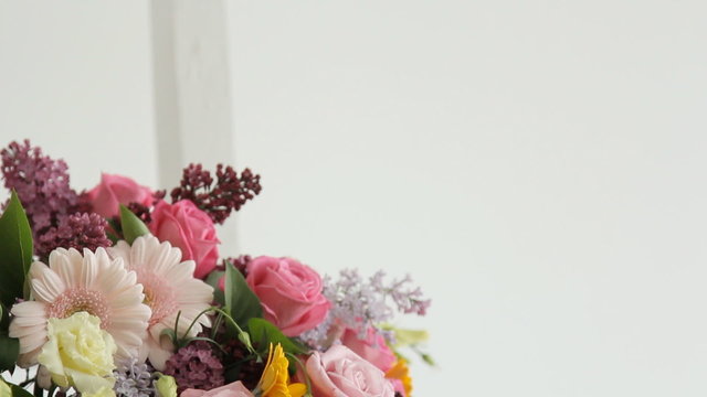 Florist makes photo on the phone of colorful bouquet composed of