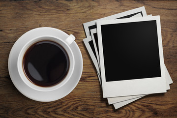Fototapeta na wymiar coffee cup and polaroid photo frames on table
