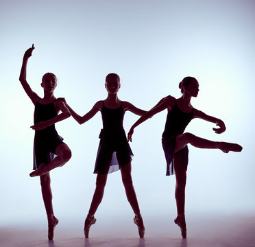 Composition from silhouettes of three young ballet dancers
