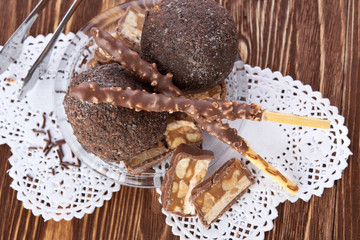 Cupcake with chocolate on wooden background