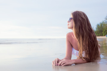 Fototapeta na wymiar portrait of woman in bikini relaxing on tropical beach