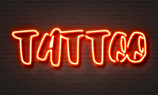 Tattoo Red Neon Sign On Brick Wall