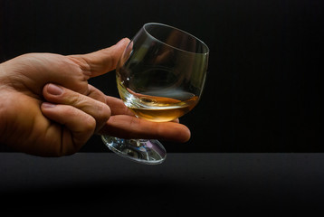 Cognac glass in human hand