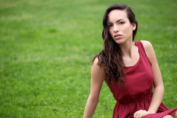 Naklejka na ściany i meble Sensual young woman portrait outdoors in a park