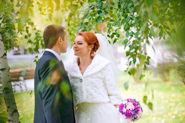 bride and groom in autumn park