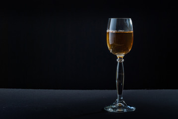 Photo of whiskey glass against black background