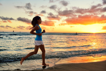 Fototapeta na wymiar Woman running and jogging training beach sunrise