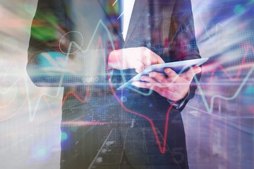 Composite image of businessman touching his tablet pc 