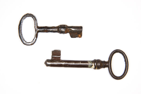 Two old keys to the safe on a white background