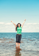 Obraz premium Happy woman in the water of sea
