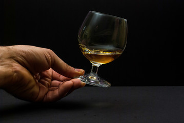 Cognac glass in human hand