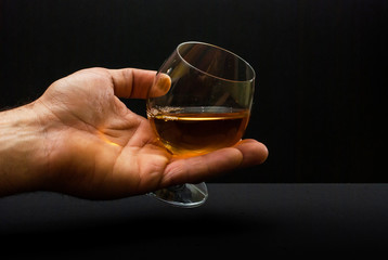 Cognac glass in human hand