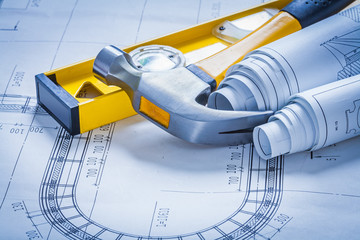 Construction level claw hammer and set of blueprints maintenance