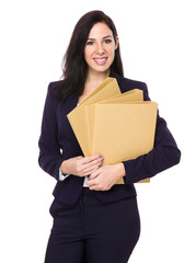 Brunette businesswoman holding with folder