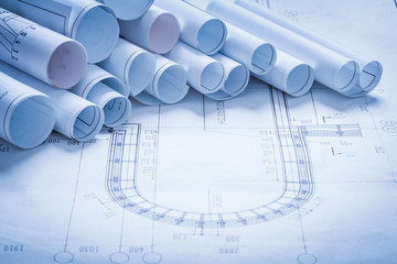 Fototapeta premium Heap of rolled up construction drawings building and architectur