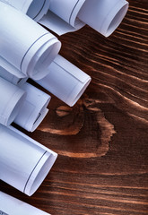 Rolls of construction plans on vintage wooden pine board mainten