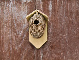 A Rustic Bird Box Made From Wood and Rope.