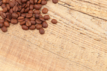 Coffee beans over old wooden table - close up shot